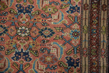 Hand-knotted vintage Hamadan rug's Herati motif, displaying madder root red, navy, and celadon green colors.
