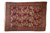 Vintage hand knotted Persian Bijar rug with multi-color rose bouquets on a deep cherry red field. 3'8