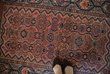 Hand knotted Persian Malayer rug with dusty rose field, navy blue floral blossoms, and trefoil designs.