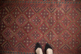 Distressed vintage Belouch runner with raspberry burgundy field and geometric navy, teal guls.