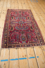 High angle view of a vintage Sarouk rug runner, showcasing its classic floral sprays and red field.