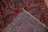 Corner view of the vintage Sarouk rug showing its hand-knotted foundation and weave.