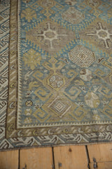 Distressed geometric guls and reciprocating wave border of an antique Caucasian rug.