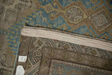 Distressed texture and geometric patterns on the secured side of an antique Caucasian rug.