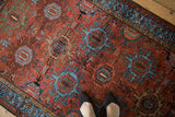 Vintage Mehreban rug with brick red field, inverted sky blue medallions, and serpent border.