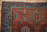 Mehreban rug's sky blue meandering vine border and beige serpent motif.