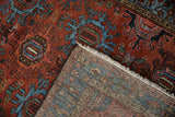 Hand-knotted Mehreban rug pile and woven foundation with fringe, displaying brick red and sky blue motifs.
