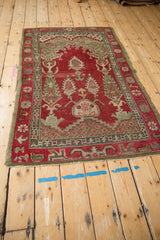Vintage Oushak rug with distinct prayer design, double cypress trees, and aged red pile.