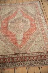 Heavily abrashed vintage Oushak rug showing starburst medallion in dusty red and beige tones.