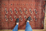 A vintage Belouch rug with unusual Turkmen geometric medallions in madder red and deep navy blue.