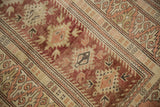 Vintage distressed Melas rug with dusty cochineal red serrated diamonds and dragon border.