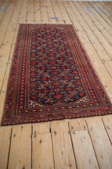 Hand-knotted vintage Turkmen rug, intricate navy Herati pattern, geometric red borders.