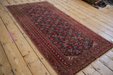 Vintage Turkmen rug corner with cherry red intricate multi-layered borders and Herati design.