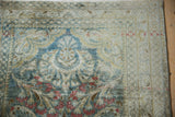 Distressed pile texture with dusty teal, madder red, and gold floral patterns.
