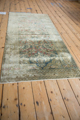 Distressed Lilihan runner with faded floral design in dusty teal, madder red, and gold.