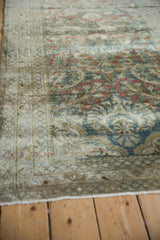 Distressed Lilihan rug runner detail with dusty teal, red floral motifs, and visible pile.
