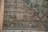 Distressed vintage Hamadan rug corner, short fringe, worn pile showing foundation, dusty teal.