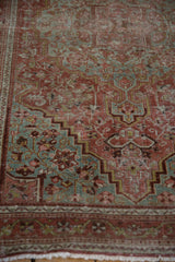 Distressed Josan Sarouk rug: stepped corner spandrel with dusty red, slate blue vinery.