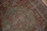 Detail of traditional Josan Sarouk rug with distressed red and slate blue-green vinery.