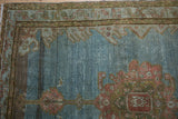 Abrashed blue field and worn knot heads on this distressed vintage Malayer rug.