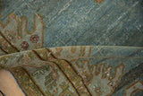 Rolled vintage Malayer rug's distressed dusty blue pile with wear to knot heads.
