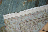 Vintage Malayer rug corner showing distressed blue-green pile, exposed foundation, and woven reverse.
