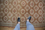 A view showing the scale and time-softened texture of a vintage Belouch rug's repeating pattern.