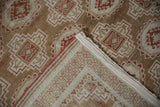 The back of the vintage Belouch rug reveals its hand-knotted weave and maze-like pawn motif.