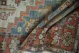 Vintage distressed Malayer runner showcasing geometric patterns in terracotta, dusty teal, and muted ivory.
