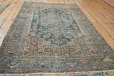 Angled perspective of a vintage Hamadan rug showing its time-softened texture and low pile.