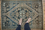 Vintage Distressed Malayer rug with dusty teal, dark beige patterns, and worn pile underfoot.