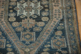 Even wear on a distressed Malayer rug, revealing dusty teal and beige geometric patterns.