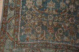 Dusty sky blue Herati motif and worn copper border on a distressed Bijar rug.