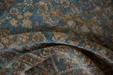 Articulated texture of the distressed Herati motif in dusty blue, pale copper, and antique ivory.
