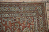 Corner of an antique Shirvan rug with layered geometric borders and Perpedil style ram's horn motifs.