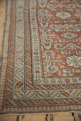 Corner detail of an antique Shirvan rug with ram's horn motifs and intricate geometric borders.