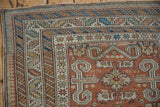 Complex corner borders of a Perpedil style Shirvan rug with geometric and scrolling motifs.