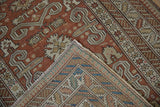 Corner detail of an antique Shirvan rug folded to show its hand-knotted foundation.