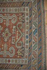 Corner detail of an antique Shirvan rug with perpedil motifs and complex geometric borders.