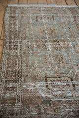 Distressed vintage Hamadan runner detail, showcasing worn dusty teal, copper brown, and ivory geometric motifs.