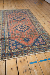 Vintage Heriz runner corner with sandalwood field, sapphire border, and pinwheel motifs.