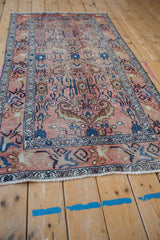 Vintage Hamadan runner with distressed rose field, featuring finned floral blossoms and textural wear.