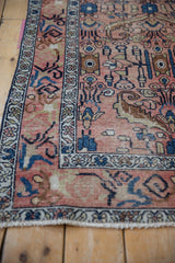 Distressed vintage Hamadan runner with worn rose field showing finned floral blossoms.