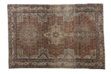 Distressed vintage Karaja rug, triple medallion with faded copper, blue, and ivory geometric floral patterns.