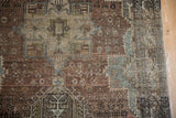 Distressed vintage Karaja rug with faint foundation visible through muted geometric patterns.