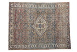 Vintage distressed Khorassan rug with an ivory diamond medallion, Herati motif, and a muted blue and red palette.