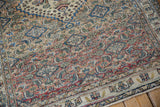 Detailed view of a distressed Khorassan rug's worn pile, showing the Herati pattern and foundation.