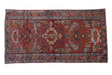 Vintage Persian Mehreban runner, cherry red field with scrolled designs and blue borders, 3'1