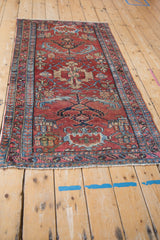 Vintage Mehreban rug close-up: cherry red field, blue serrated leaf border pattern.