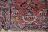 Vintage Mehreban runner's cherry red field, serrated leaf border, and hand-knotted fringe.